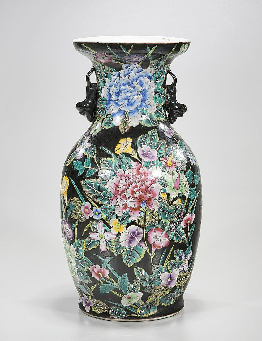 Chinese Enameled Porcelain Vase: Chinese enameled porcelain vase; floral design on black ground; 14 1/2" x 7 1/2"(approx.) Condition: wear, frits, pits, minor loss