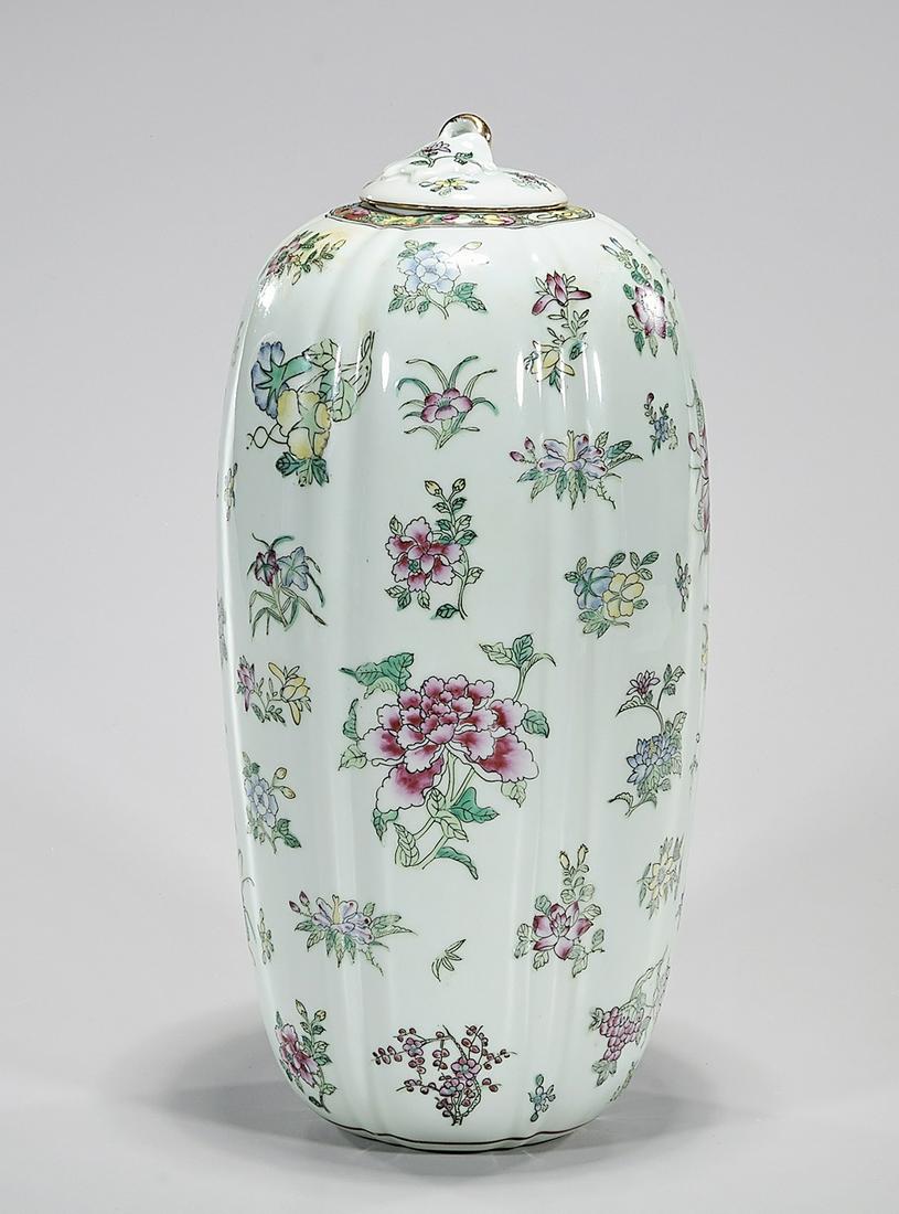 Chinese Enameled Porcelain Covered Vase: Chinese enameled porcelain covered vase with floral motif; 15" x 7" (approx.) Condition: general wear, frits, pits, minor chips