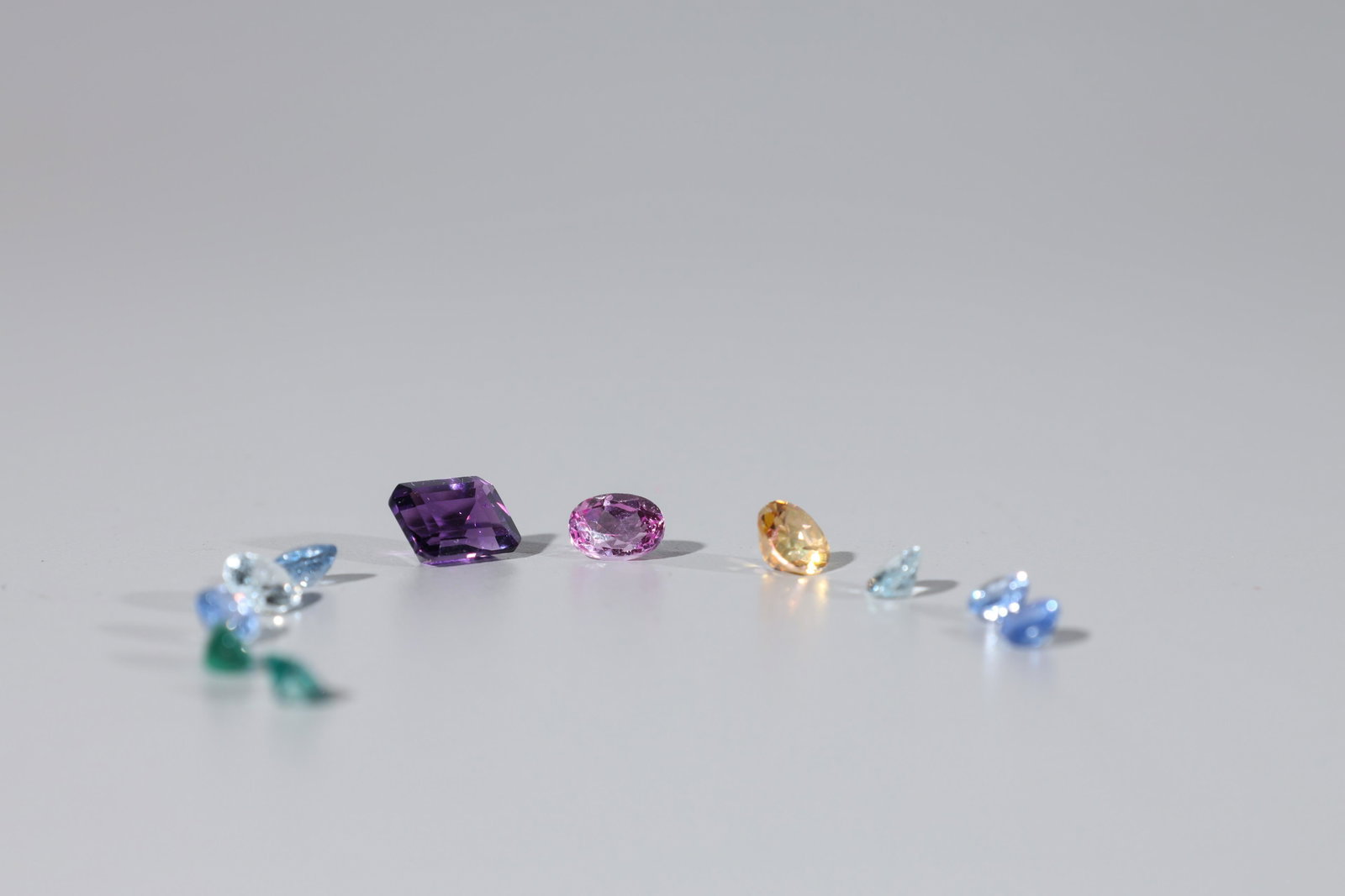 Group Of Eleven Loose Gemstones: Group of eleven loose faceted gemstones; including aquamarine, emerald, tanzanite, amethyst, and topaz; approx. 11 cts. total weight