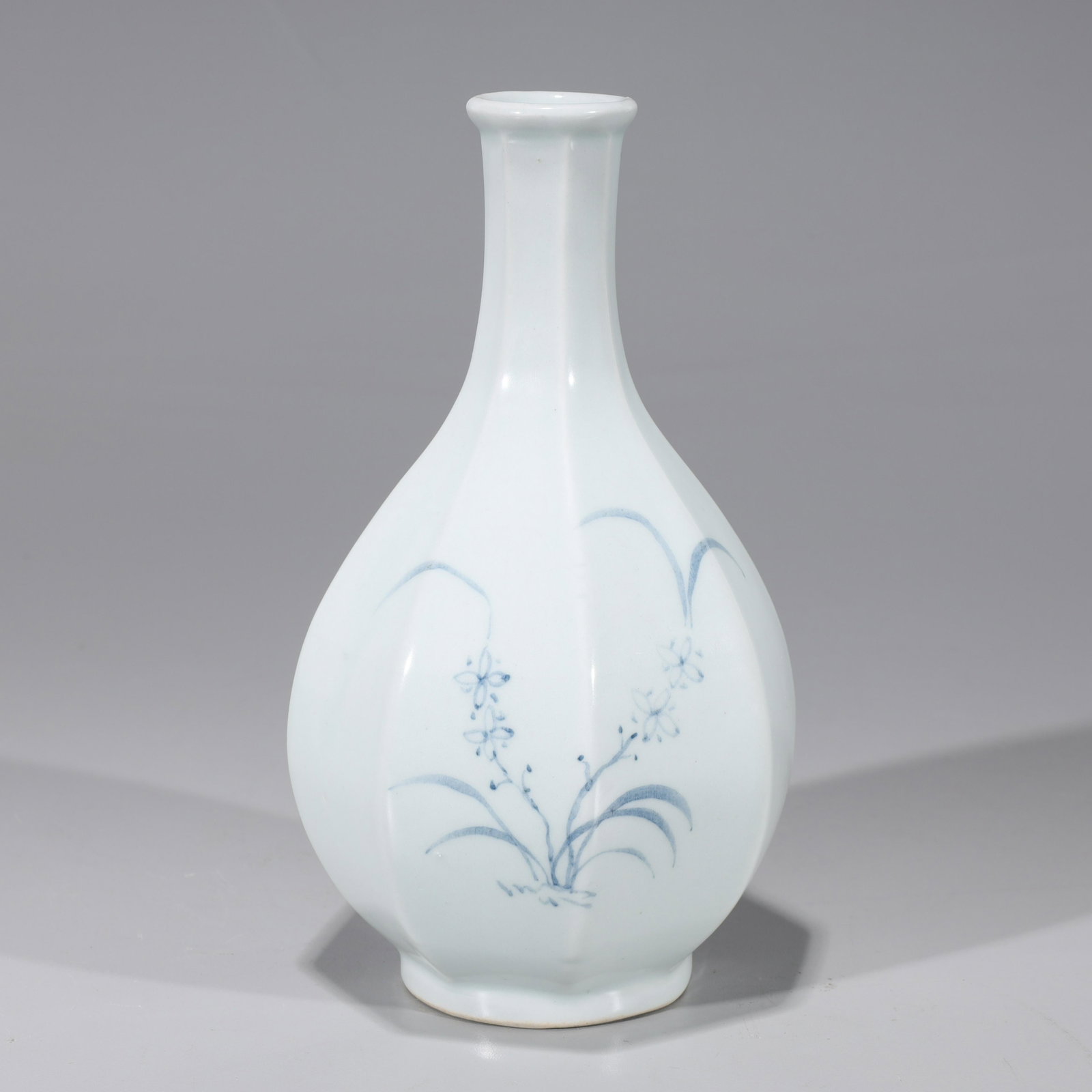 Korean Blue & White Porcelain Faceted Vase: Korean blue and white porcelain faceted vase with floral designs; overall good condition, minor surface wear, minor glaze flaws; H 8" x D 4 1/2" (approx.)