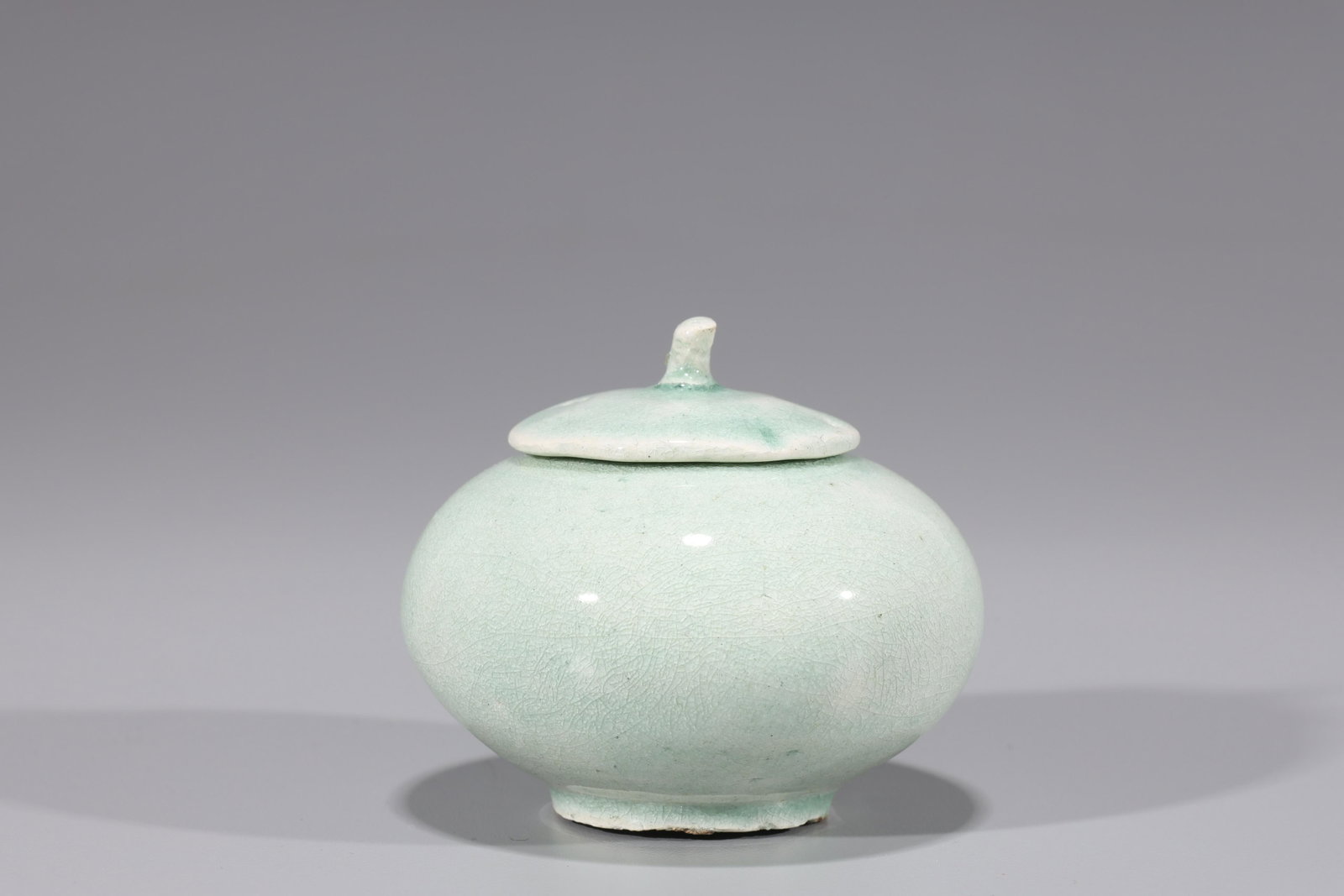 Korean Celadon Glazed Covered Jar: Korean Celadon glazed covered jar; chip to lid; D: 3 1/4" (approx.)