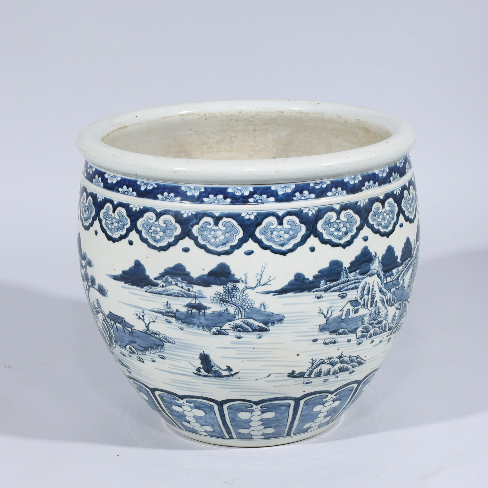 Chinese Blue & White Porcelain Jardiniere: Chinese blue and white porcelain jardiniere with river scenes; some wear, some firing flaws, some minor soiling; H 14 1/2" x D 16 1/2" (approx.)