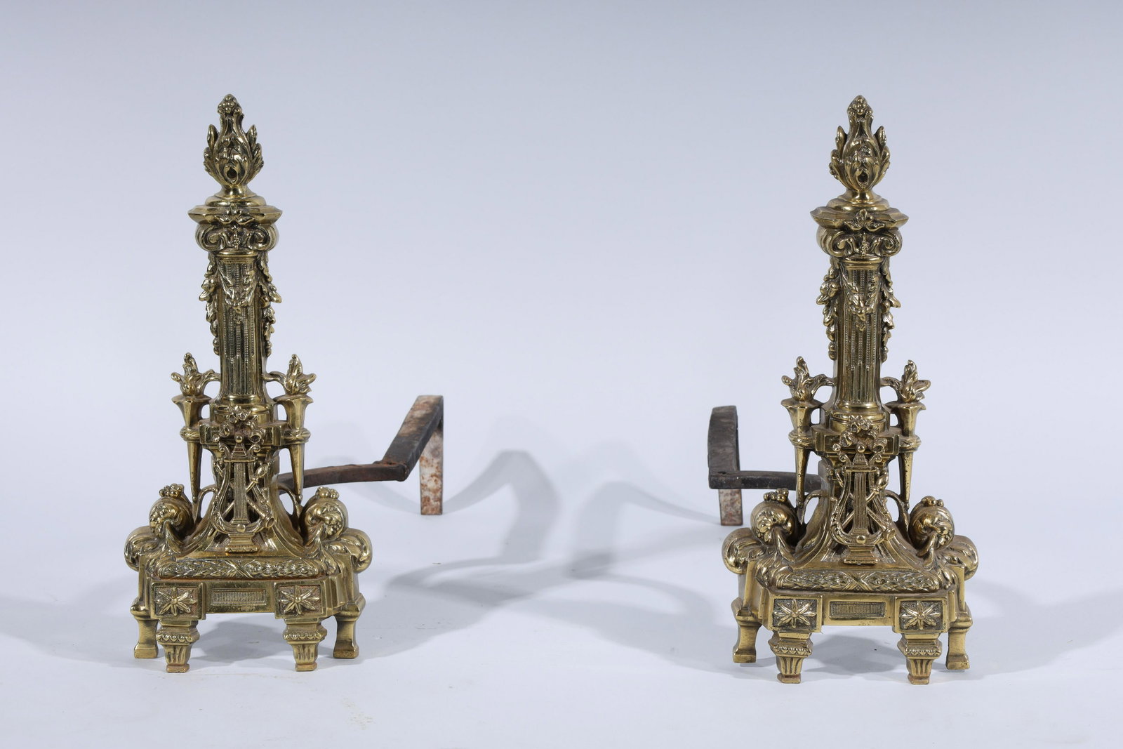Pair of Brass Gold Fireplace Andirons: Pair of brass gold fireplace andirons; with elaborate gold design; each measuring 22" x 16" (approx.)