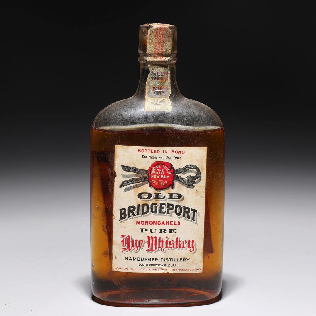 Old Bridgeport Rye Whiskey 7 Years Old 1917: Single bottle of Old Bridgeport rye whiskey aged 7 years, distilled in 1917 and bottled in 1924 in Hamburger Distillery, South Brownsville, PA.Provenance:Private Sherman Oaks, CA collection**Please No