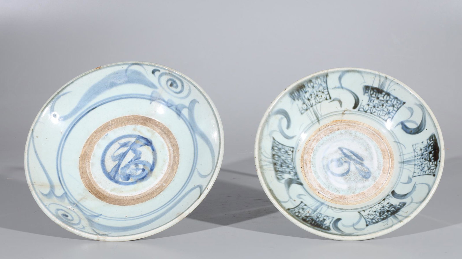 Two Large Antique Chinese Ceramic Bowls: Two large antique Chinese early style blue and white ceramic bowls, one with initials to bottom; some wear, some pitting and minor chips, with a few hairline cracks to each; the larger H 3 1/8" x D 11