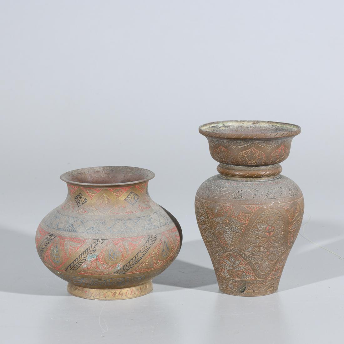 Two Indonesian Brass Holy Water Vessels: Two Indonesian Brass Holy Water Vessels, both with beautifully detailed leaf and floral incised designs. Tallest vase has numbering hand sketched in '18697' the smaller has a number stamped in '18742'