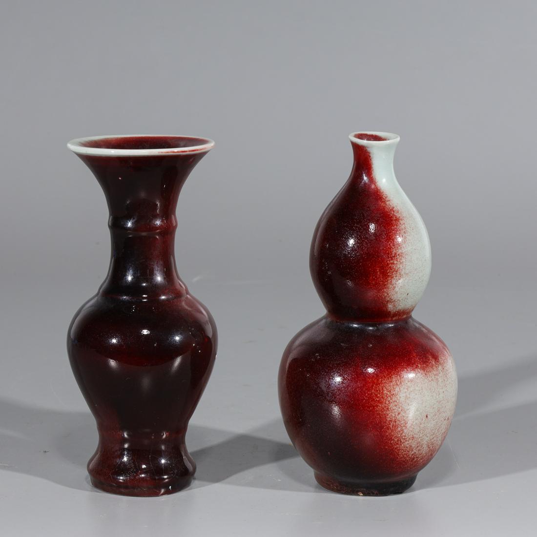 Two Chinese Sang de Boeuf Vases: Two Chinese sang de boeuf vases including one double-gourd form with four-character mark to base, and one beaker style with six-character mark to base; overall good condition, minor wear and pitting; 