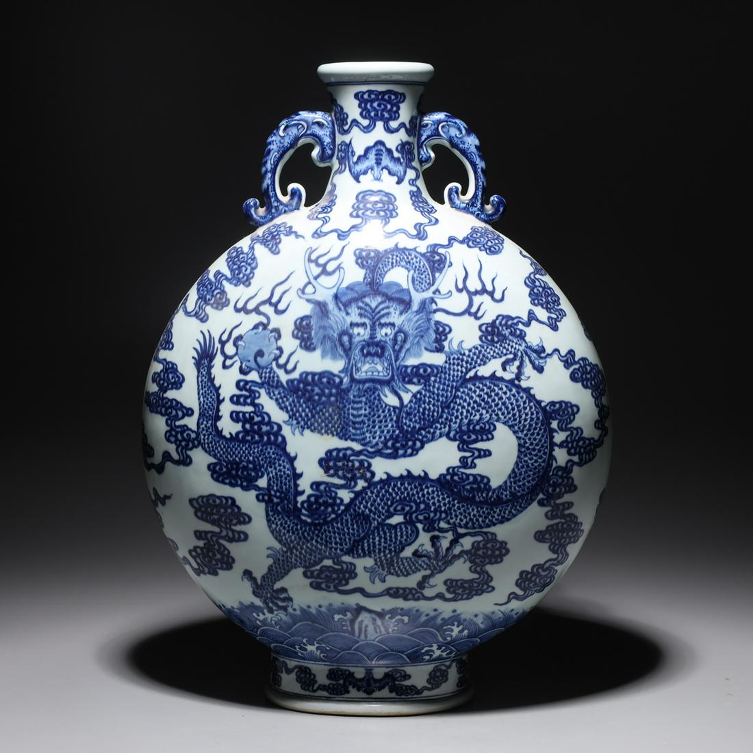 Chinese Blue & White Porcelain Dragon Vase: Chinese blue and white dragon vase with flaming pearl and bat designs amidst clouds, with molded handles and six-character Qianlong mark to base; overall good condition, minor wear, crack to base rim;