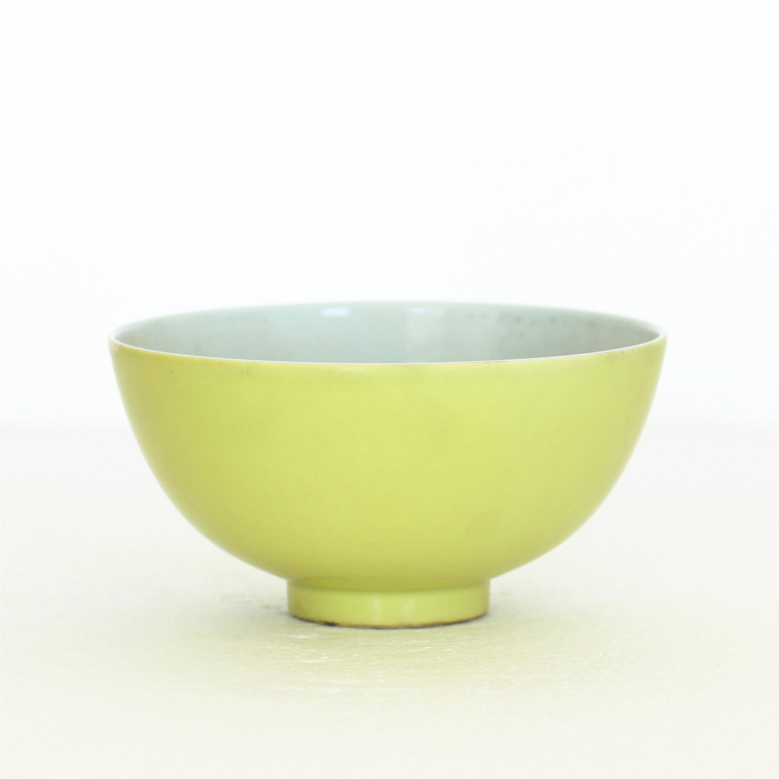 Chinese Lemon-Yellow Glaze Porcelain Bowl: Chinese lemon-yellow glazed porcelain bowl with YongZheng mark to bottom; scattered nicks on the bottom foot, surface wear and glaze imperfections; H 2-5/8" x W 5 1/4"
