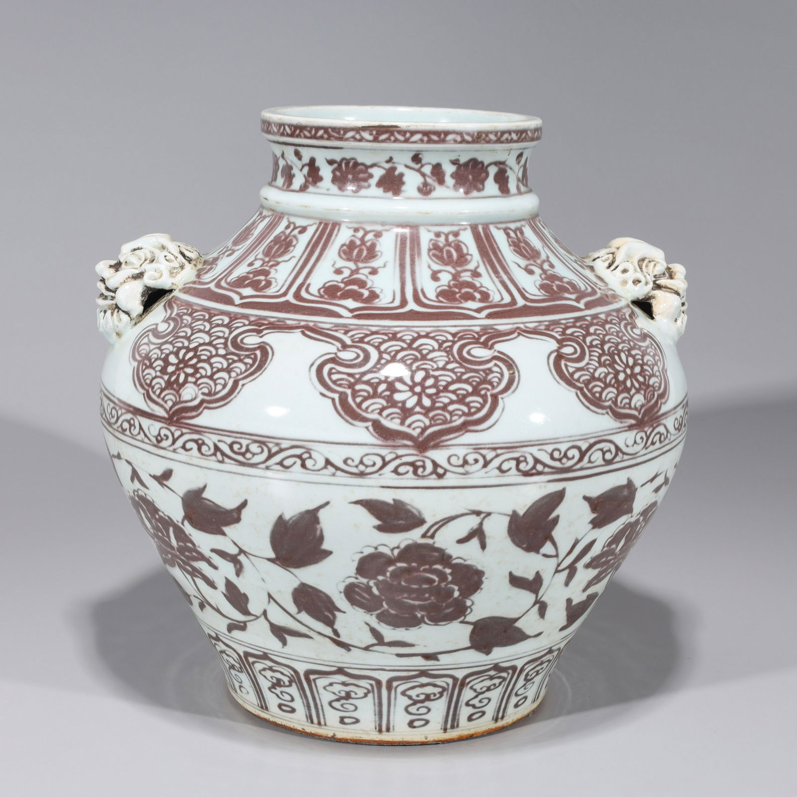 Chinese Yuan Style Underglazed Red & White Porcleain: Large Chinese Yuan style underglazed red and white porcelain jar with floral designs and elaborate mask handles; some surface wear and scratches, minor flaws, minor losses to glaze, minor chips to foo