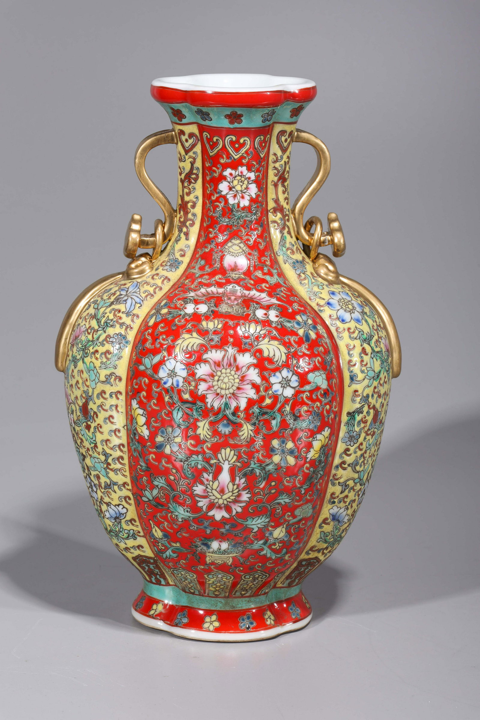 Elaborate Chinese Enameled Porcelain Vase: Elaborately designed Chinese gilt and enameled porcelain vase, with gilt ruyi handles, floral, bat, and peach designs, four-character mark to base; some minor wear, minor losses to enamel and gilt, mi