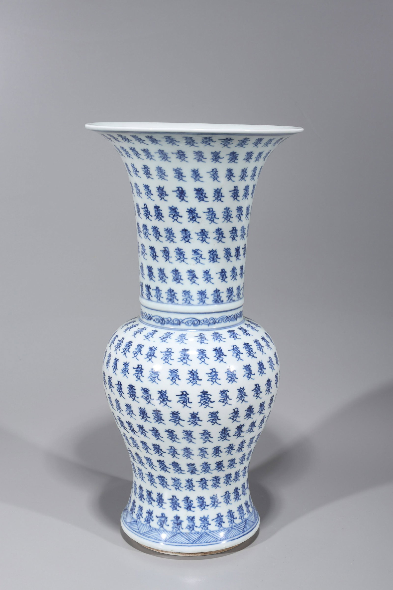 Chinese Kangxi Style Blue & White Porcelain Vase: Chinese Kangxi style blue and white porcelain vase with allover repeating calligraphy, flared rim, double concentric ring mark to base but post-1950; overall good condition, some surface wear, minor s