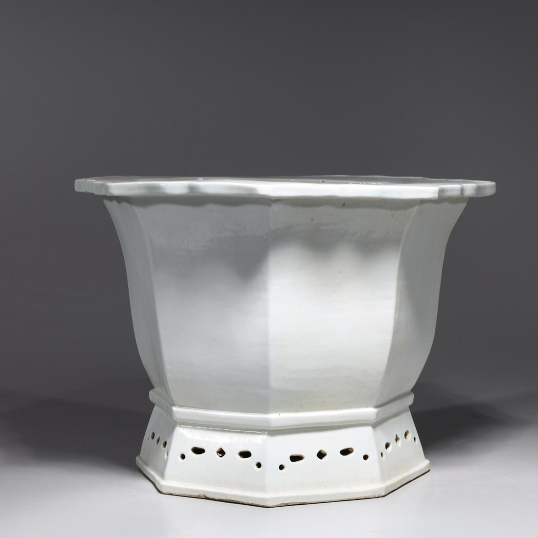 White Glazed Chinese Porcelain Planter: Chinese white glazed octagonal porcelain planter with molded rim; overall good condition, minor wear and firing flaws, with hole drilled to bottom; H 10" x W 14 1/2" (approx.)