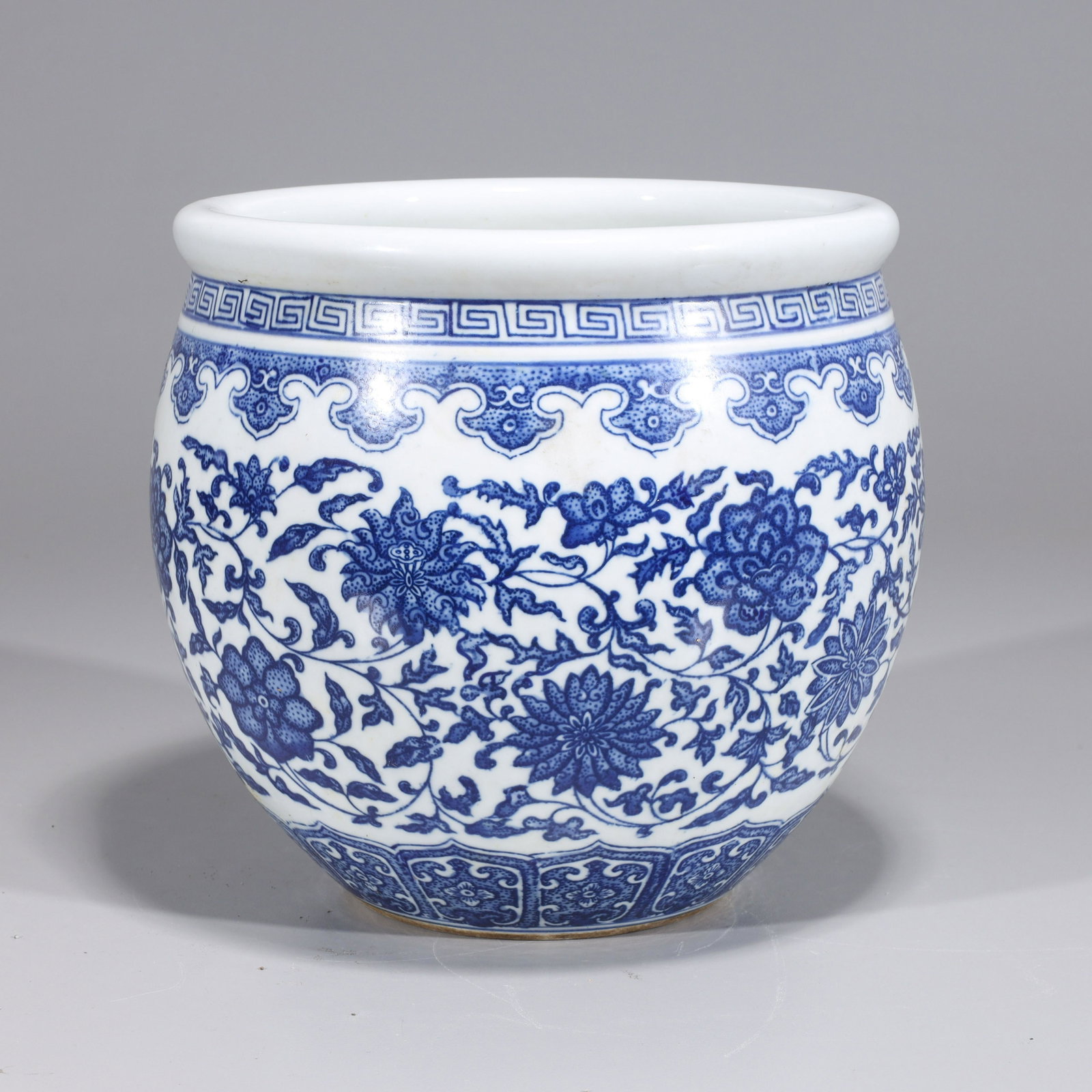 Chinese Blue & White Porcelain Vase: Chinese blue and white porcelain vase with allover floral design and six-character Qianlong mark to base but later, post-1950; overall good condition, minor wear; H 7 1/2" x D 7 3/4" (approx.)