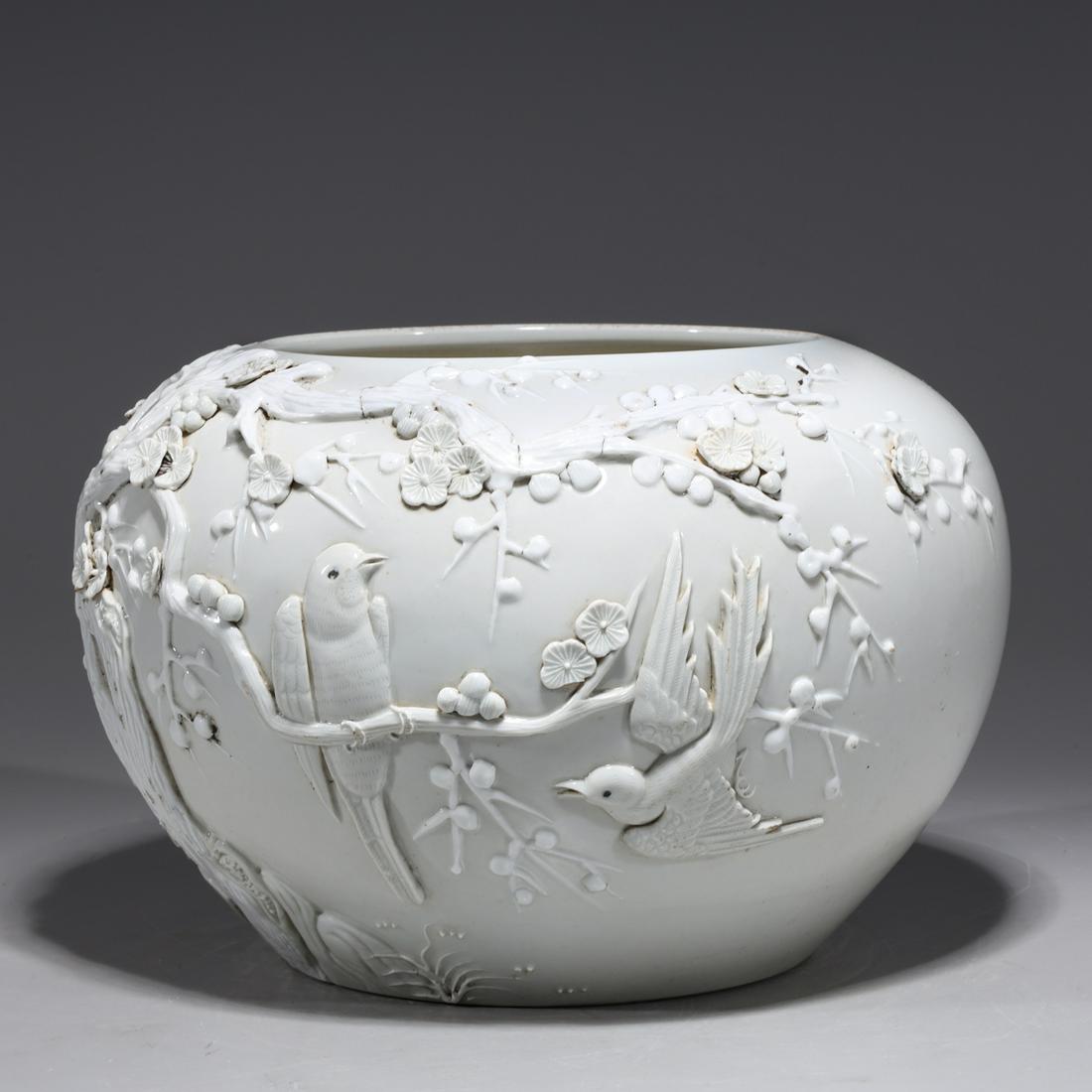 Chinese White Glazed Bird & Flower Porcelain Vase: Chinese white glazed porcelain vase with bird and flowering trees in high relief, with four-character mark to base; overall good condition, firing cracks to tree and minor soiling; H 7" x D 10 1/4" (a
