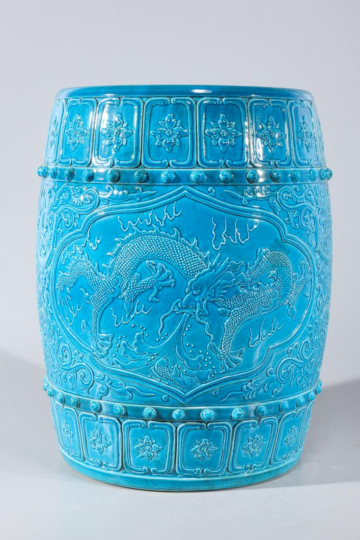 Chinese Blue Glazed Porcelain Garden Seat: Chinese blue glazed porcelain garden seat with molded dragons and floral designs to body; overall good condition; H 17" x D 13 1/2" (approx.)