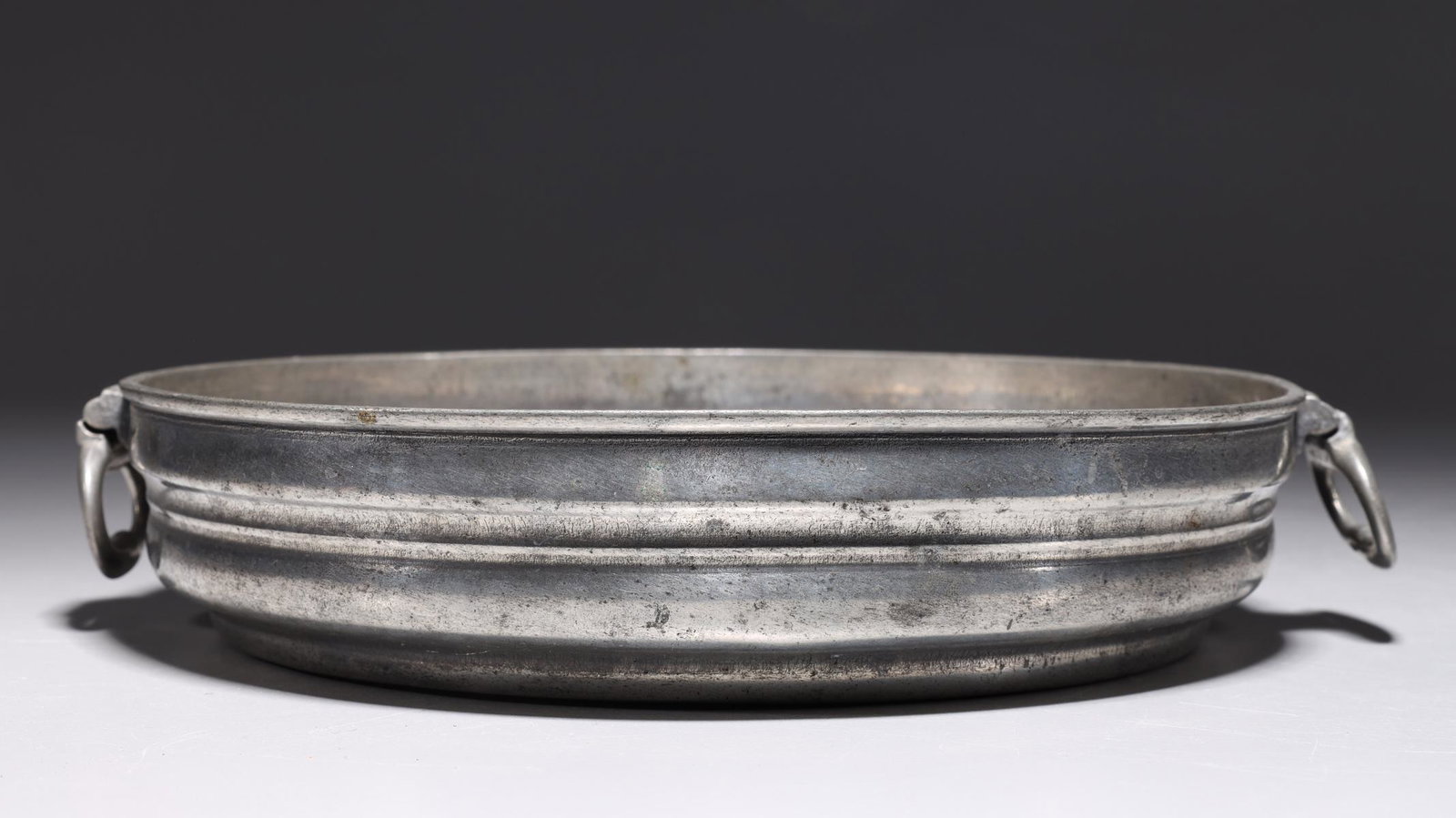 George III Pewter Dish: George III pewter dish with handles with receipt from The General Trading Company (Mayfair) Ltd; overall good condition, commensurate wear; H 1 3/4" x D 9" (approx.)
