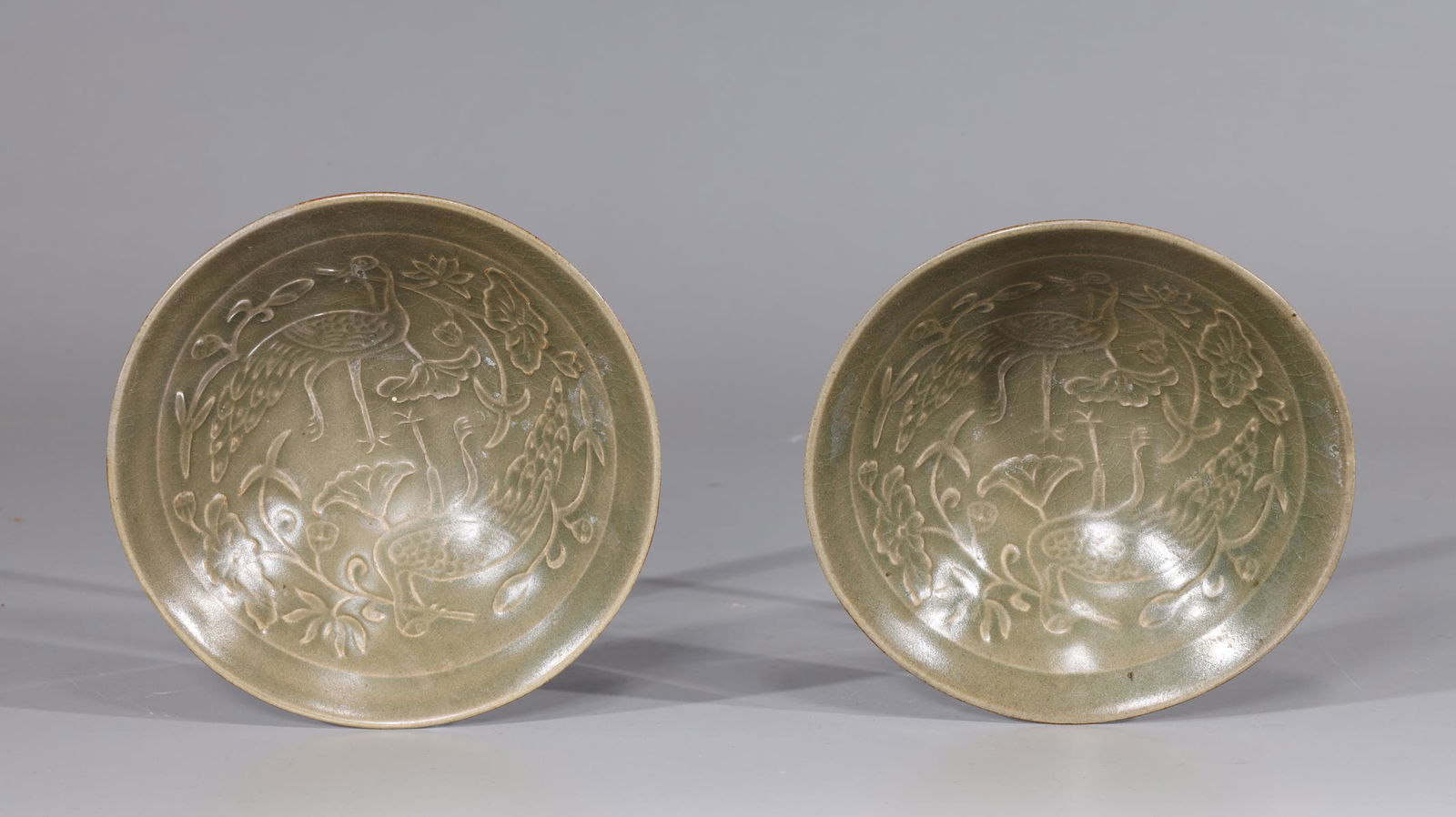 Pair of Chinese Celadon Glazed Bowls: Pair of Chinese celadon glazed bowls with incised bird and floral designs to interior; overall good condition; H 2" x D 5 7/8" (approx.)