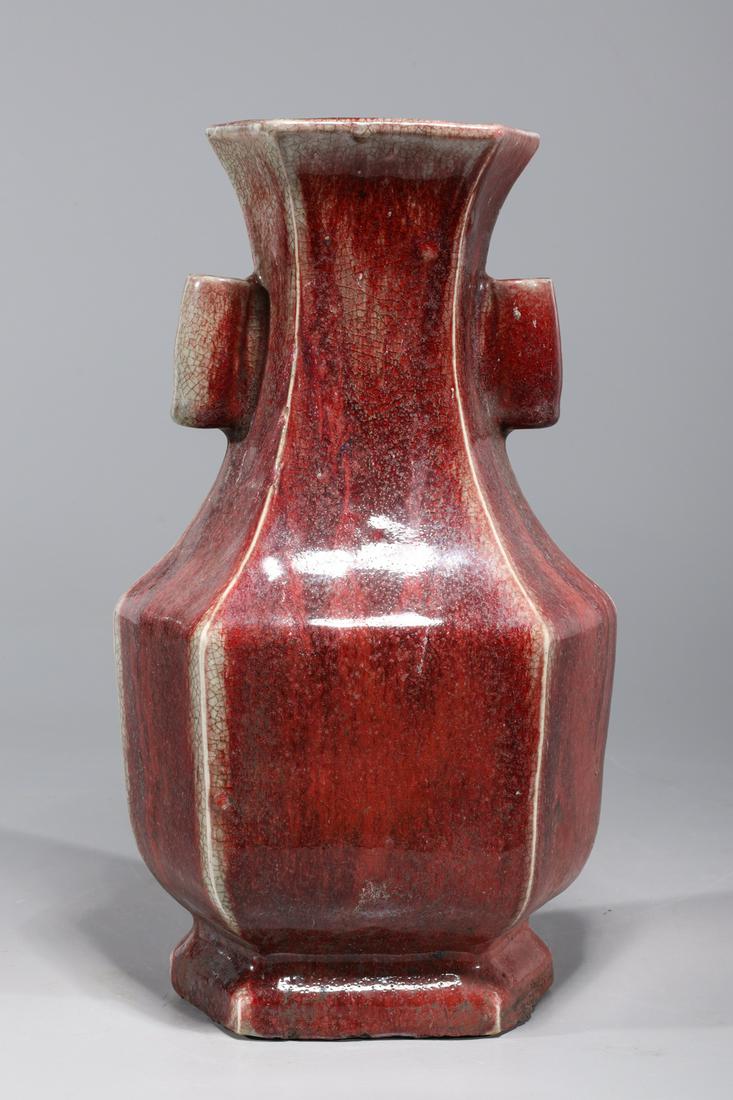 Chinese Sang de Boeuf Faceted Porcelain Vase: Chinese sang de boeuf faceted porcelain vase with molded handles to neck; overall good condition; H 12" x W 6 3/4" x D 5 1/4" (approx.)