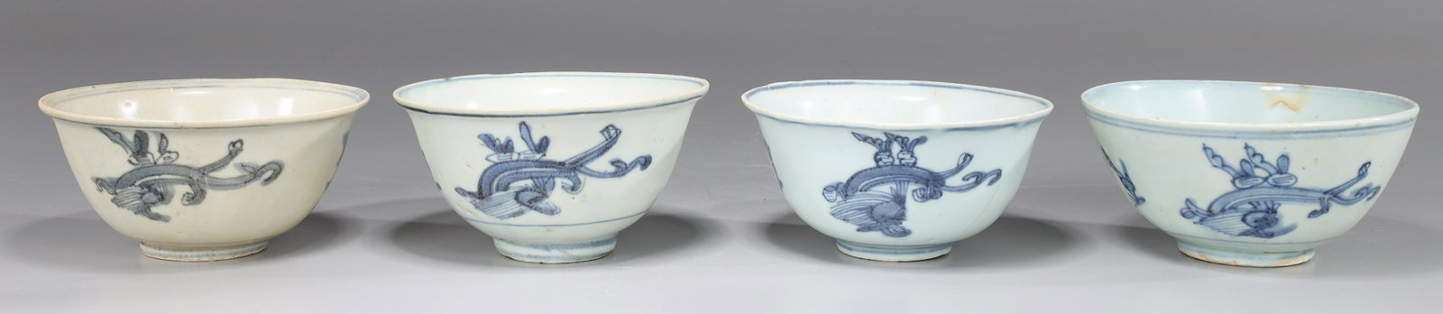 Group of Five Chinese Ming Dynasty Porcelain Bowls: Group of five Chinese Ming Dynasty blue and white porcelain bowls with floral designs to interior and exterior, one with four character mark to base; as-is condition with numerous firing flaws, chips,