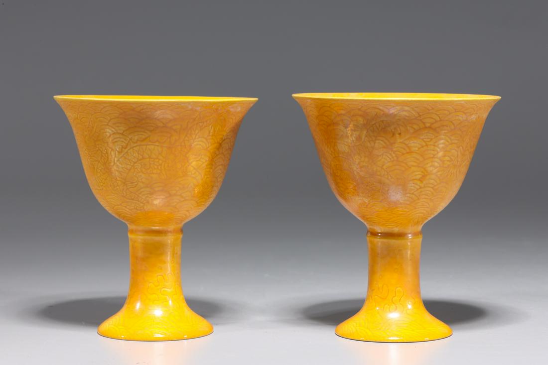 Two Chinese Yellow Ground Porcelain Wine Cups: Two Chinese yellow ground porcelain wine cups with incised dragon designs to body and six-character Chenghua mark to base; overall good condition; each H 3 7/8" x D 3 3/8" (approx.)