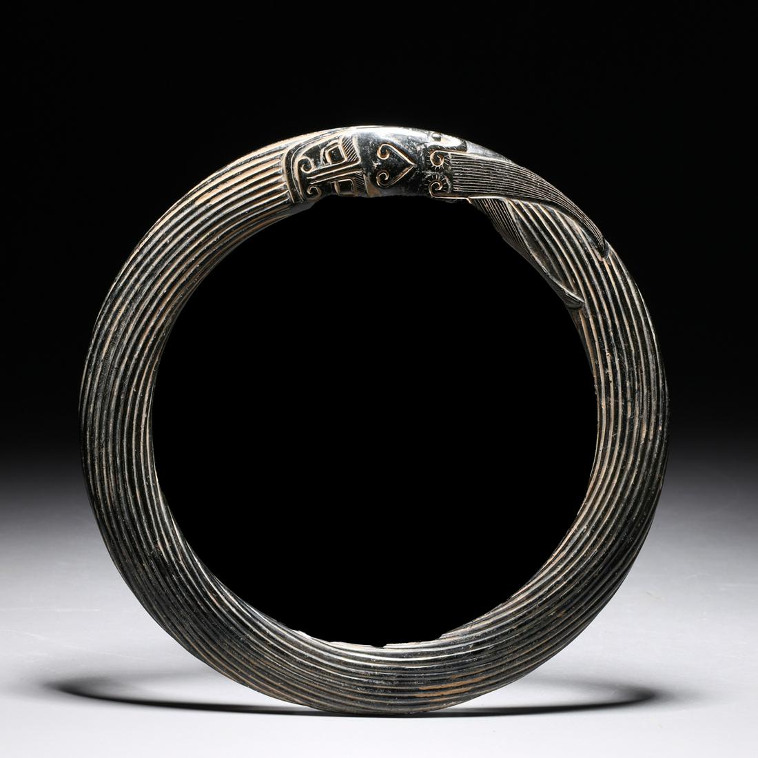 Unusual Chinese Carved Disc: Unusual Chinese carved disc of rope design terminating in mask form; as-is condition with wear, loss, flaws and cracks; W 6 3/4"