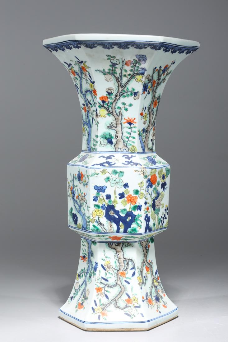 Chinese Famille Verte Enameled Porcelain Faceted Beaker Vase: Chinese famille verte enameled porcelain faceted beaker vase with trees and flowers to body, six-character Kangxi mark to base; overall good condition; H 14 1/4" x D 8" (approx.)