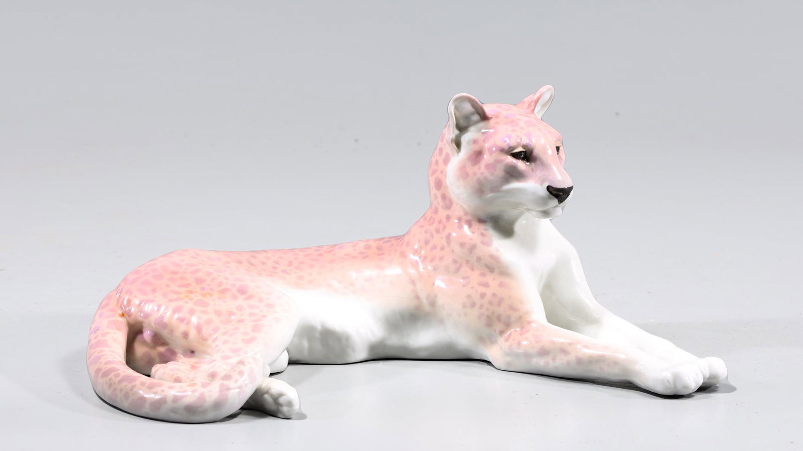 Nymphenburg Porcelain Lying Panther: Nymphebburg porcealin lying panther, number 153; sun bleached glaze, light age wear, light surface wear, surface soiling; L 9 1/2" W 5 1/2" H 4 1/2" (Approx.)
