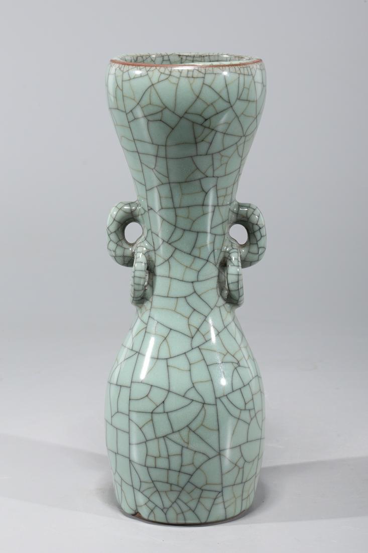 Chinese Celadon Crackle Glazed Porcelain Vase: Chinese celadon crackle glazed porcelain vase with molded handles and rings; overall good condition; H 10 1/8" x D 3 3/4" (approx.)