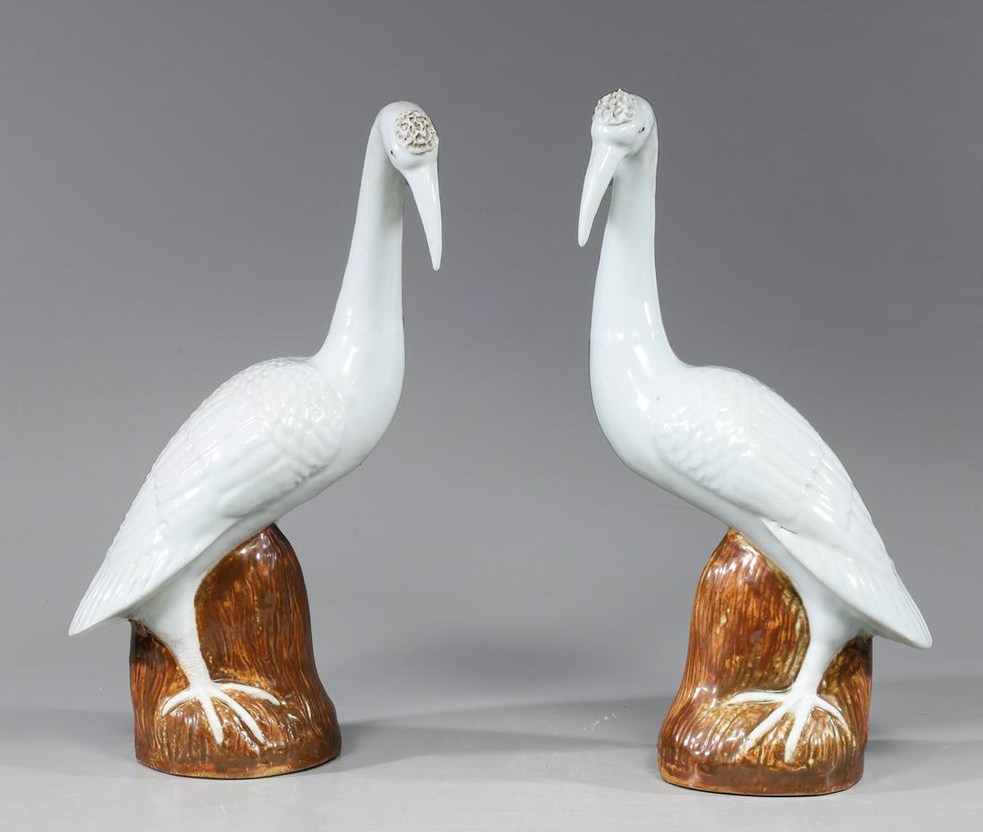 Pair Chinese Glazed Porcelain Birds: Pair Chinese white glazed porcelain birds, each atop brown glazed rockery; good condition with minor surface wear and flaws; larger H 16 1/4"