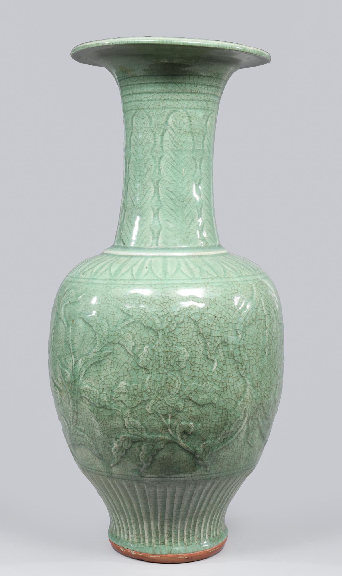 Large Chinese Celadon Glazed Crackle Vase: Large Chinese celadon crackle glazed ceramic vase, the body with molded designs of flowers, vines and tendrils beneath a neck with leaf patterns; H 24 1/4"