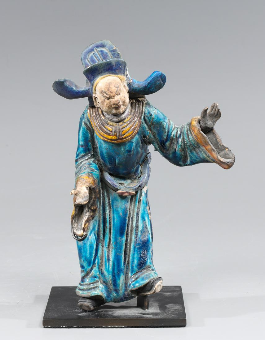 Chinese Ming Dynasty Pottery Roof Tile: Chinese Ming dynasty blue glazed pottery roof tile in the form of a standing figure with elaborate hat, mounted on custom metal base; as-is condition, figures left arm broken and re-attached, other cr