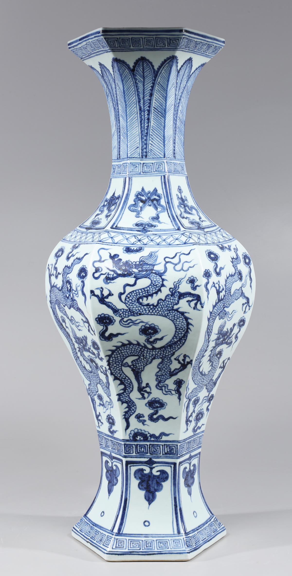 Tall Chinese Blue & White Porcelain Dragon Vase: Tall Chinese hexagonal blue and white porcelain dragon vase, the body elaborately detailed with six writhing dragons in various positions amidst storm clouds between geometric boarders and leafs to ne