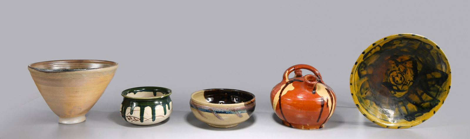 Group of Five Mid Century Drip Glaze Studio Pottery: Group of five mid century drip glaze studio pottery; tea pot: minor nick on spout rim, raw glaze edge on base; tall bowl: irregular glazing, minor wear on base; small lipped bowl: attributed, small ch