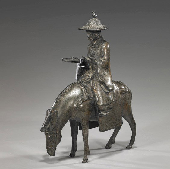 Chinese Bronze Sage on a Donkey: Chinese Bronze Sage on a Donkey Chinese bronze model of a sage; wearing a wide-brimmed hat and carrying a scroll while riding a donkey, early 20th Century; H: 12"
