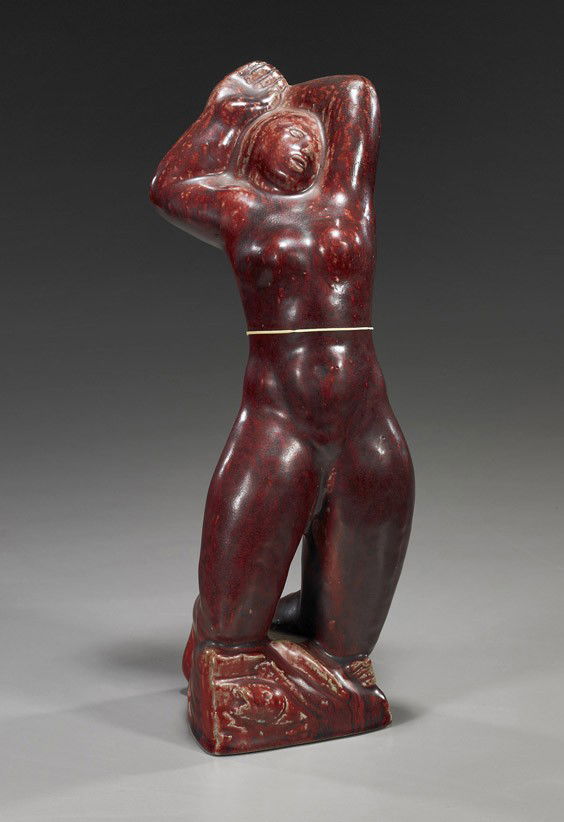 Royal Copenhagen Glazed Stoneware Nude: Royal Copenhagen Glazed Stoneware NudeRoyal Copenhagen oxblood glazed stoneware nude, by Jais Nielsen; kneeling on rockery and with hands above her head, signed bottom with "3 waves" mark and numbered