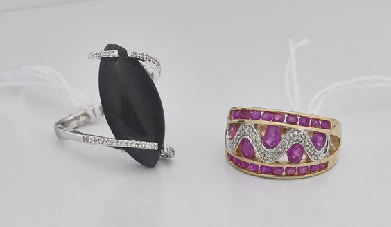 Two Ladies' Rings: Onyx & Ruby: Two Ladies' Rings: Onyx & Ruby Two ladies' rings: 14K white gold modern band set with small round-cut diamonds and embracing a marquise-form cabochon black onyx, Size: 7; together with a yellow gold b