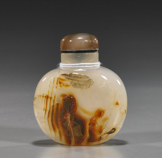 Cameo Carved Agate Snuff Bottle: Cameo Carved Agate Snuff BottleFinely hollowed, Chinese cameo-carved chalcedony agate snuff bottle; of flattened round form with sage and attendant to the front, brown carnelian color, agate stopper (