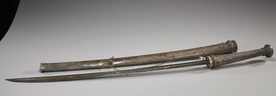 Old Thai Sword in Repousse Silver: Old Thai Sword in Repousse SilverOld repoussé silver mounted Thai sword and scabbard; with elaborate floral motifs to the handle and sheath (considerable wear), probably antique; L: 38"