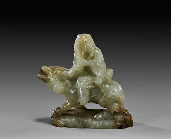 CARVED CELADON JADE SAGE & DONKEY: CARVED CELADON JADE SAGE & DONKEYElaborately carved, Chinese yellowish celadon jade group: of an Immortal sage riding on the back of a donkey; the jade with some brown-tan mottling and with rivering t