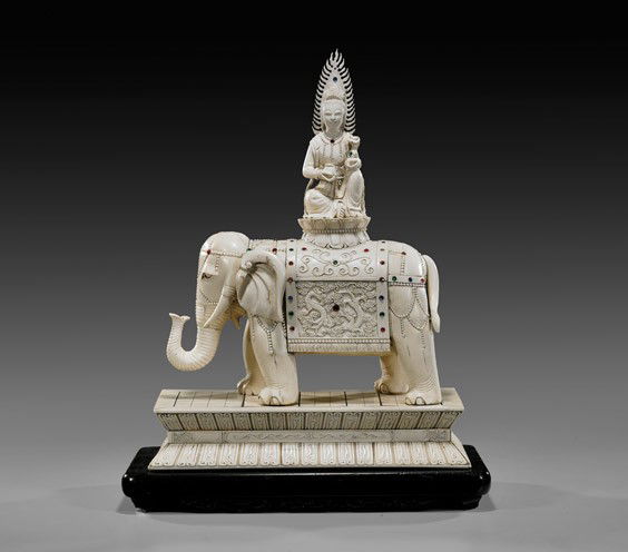 JEWELED IVORY ELEPHANT GROUP: JEWELED IVORY ELEPHANT GROUPLarge Chinese carved, sectional ivory model of a Bodhisattva seated on a lotus pedestal; in the position of "Royal Ease": holding a scepter and with mandorla behind; seated