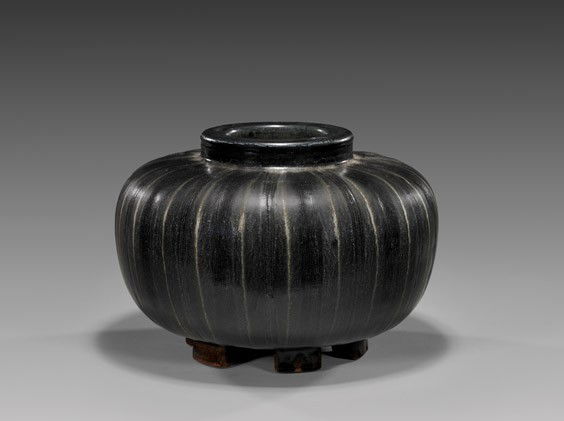 GUSTAVBERG JAR BY WILHELM KAGE: GUSTAVBERG JAR BY WILHELM KAGELarge Gustavsberg stoneware jar by Wilhelm Kage (Sweden, 1899-1960); from the Farsta series, of attractive slightly lobed squat form, with dark brown glaze and set on set
