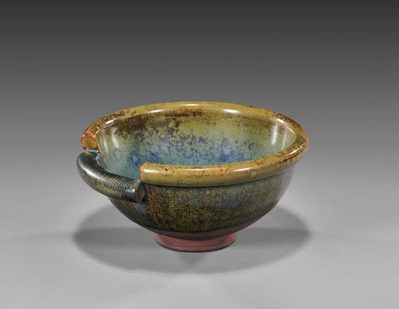 GUSTAVBERG BOWL BY WILHELM KAGE: GUSTAVBERG BOWL BY WILHELM KAGESmall Gustavsberg bowl by Wilhelm Kage (Sweden 1899-1960): of rounded footed form with lipped rim, with a cut and lowered section; the interior feathered blue similar to