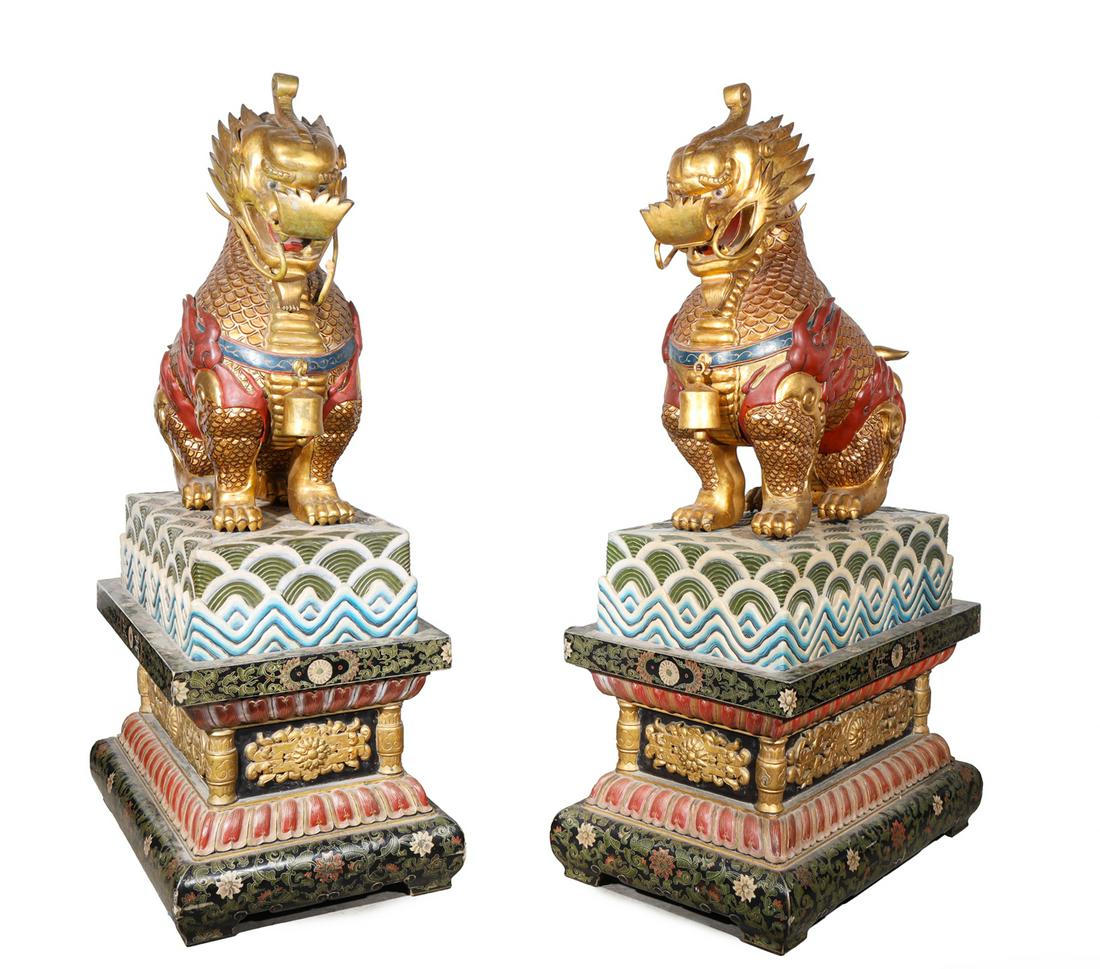 Pair Colossal Chinese Gilded Lions: Pair of colossal well adorned Chinese gilded lion with elaborate base with openwork, ocean waves in high relief, famille noire frieze; as is condition, broken tail and beard, cracks, flaws, losses, ag