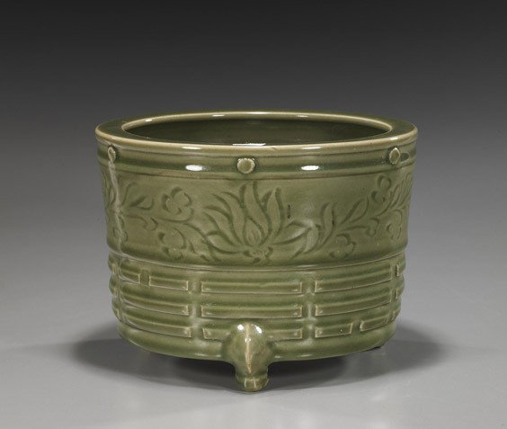 Chinese Celadon Glazed Tripod Censer: Chinese Celadon Glazed Tripod Censer Chinese celadon glazed tripod censer; somewhat cylindrical with incised florals and Buddhist trigrams; in Yuan/early Ming-style; D: 8"