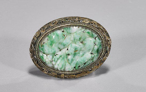 Chinese Jadeite Brooch: Chinese Jadeite Brooch in Silver Filigree Chinese silver filigree brooch; set with an oval openwork carved moss-in-snow jadeite plaque with apple green mottling and depicting rabbits among foliage, ea