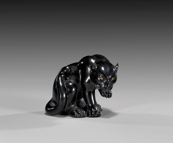 CONTEMPORARY IVORY NETSUKE: Panther: CONTEMPORARY IVORY NETSUKE: Panther Contemporary carved and black lacquered ivory netsuke; of a sleek panther with one paw up and with golden inlaid eyes, by Shingetsu(?); signed