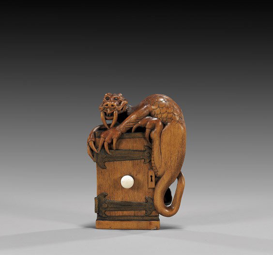 CONTEMPORARY WOOD NETSUKE: Dragon & Door: CONTEMPORARY WOOD NETSUKE: Dragon & Door Contemporary carved wood netsuke; of a somewhat medieval European-style dragon with inlaid eyes, guarding over and clutching onto a door; with a single central