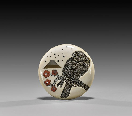CONTEMPORARY IVORY MANJU NETSUKE: CONTEMPORARY IVORY MANJU NETSUKE Contemporary carved ivory circular manju netsuke; the front with a finely detailed hawk inlaid cherry blossoms and mountain, verso with scene of a pagoda and crescent 