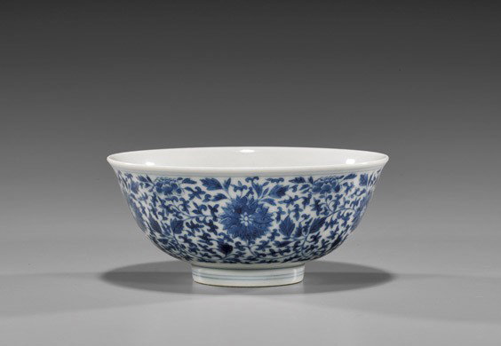 YONGZHENG BLUE & WHITE PORCELAIN BOWL: YONGZHENG BLUE & WHITE PORCELAIN BOWL Early 18th Century, Chinese blue and white porcelain bowl; the exterior with Buddhist design of lotus blossoms amid other florals and meandering foliage; Yongzhen